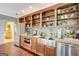 Modern kitchenette with stainless steel appliances, granite countertops, and open shelving for storage and display at 606 Wingspread, Peachtree City, GA 30269