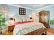 Elegant main bedroom with large bed, patterned linens, and ample natural light, creating a luxurious retreat at 606 Wingspread, Peachtree City, GA 30269
