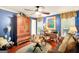 Cozy office with hardwood floors, ample seating, a ceiling fan and an abundance of artwork at 606 Wingspread, Peachtree City, GA 30269