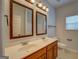 Bright bathroom featuring a double vanity with a large mirror and modern lighting at 9187 Golfside Cir, Covington, GA 30014