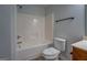 Bathroom featuring bathtub with shower, toilet and tile floor at 9187 Golfside Cir, Covington, GA 30014