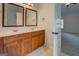 Bathroom features double sink vanity, neutral tile flooring, and access to the bedroom at 9187 Golfside Cir, Covington, GA 30014