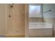 Bright bathroom with tub, shower and neutral finishes at 9187 Golfside Cir, Covington, GA 30014