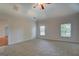Spacious bedroom featuring neutral carpeting, a ceiling fan and two windows at 9187 Golfside Cir, Covington, GA 30014