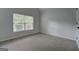 Bedroom with neutral walls and carpet, and a large window at 9187 Golfside Cir, Covington, GA 30014