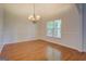 Features a classic chandelier and natural light from the window, perfect for gatherings at 9187 Golfside Cir, Covington, GA 30014