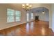 This dining area features hardwood floors, a chandelier, and is connected to the living room at 9187 Golfside Cir, Covington, GA 30014