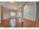 Open dining room featuring hardwood floors, decorative trim, and large windows for natural light at 9187 Golfside Cir, Covington, GA 30014