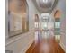 Entryway featuring hardwood flooring, an arched ceiling, and elegant light fixture at 9187 Golfside Cir, Covington, GA 30014