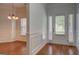 Entryway featuring wood flooring, crown molding, and natural light at 9187 Golfside Cir, Covington, GA 30014