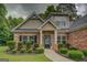 Charming brick home with a well-manicured front yard and a covered front entry at 9187 Golfside Cir, Covington, GA 30014