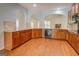 Well-lit kitchen with granite countertops, wooden cabinets, and ample space at 9187 Golfside Cir, Covington, GA 30014