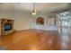 Open-concept living space with hardwood floors, a stone fireplace, and arched entryways to other rooms at 9187 Golfside Cir, Covington, GA 30014
