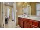 Bright bathroom with a single vanity, tile floors, and a doorway leading to other rooms in the home at 705 Lawton Bridge Sw Rd, Smyrna, GA 30082