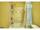 Bathroom featuring a tub-shower combo with patterned tile surround at 705 Lawton Bridge Sw Rd, Smyrna, GA 30082