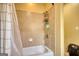 Neutral colored bathroom with a shower/tub combo, tiled walls, and a shower curtain at 705 Lawton Bridge Sw Rd, Smyrna, GA 30082