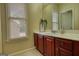 Bathroom with a single vanity, large mirror, and window with great natural light to brighten up the space at 705 Lawton Bridge Sw Rd, Smyrna, GA 30082