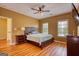 Well-lit bedroom featuring warm colors, hardwood floors, and large windows offering great natural light at 705 Lawton Bridge Sw Rd, Smyrna, GA 30082