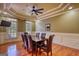 Formal dining room features hardwood floors, a tray ceiling, and elegant wainscoting at 705 Lawton Bridge Sw Rd, Smyrna, GA 30082