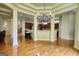 Open dining room showcasing hardwood floors, chandelier, and seamless flow to kitchen with cherry wood cabinets at 705 Lawton Bridge Sw Rd, Smyrna, GA 30082
