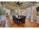 Dining room with hardwood floors, decorative columns, and a view into the adjoining living spaces at 705 Lawton Bridge Sw Rd, Smyrna, GA 30082