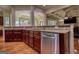 Kitchen space with wood cabinets, a stainless steel dishwasher, and granite countertops at 705 Lawton Bridge Sw Rd, Smyrna, GA 30082