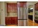 Modern kitchen appliances with wood cabinets, a stainless steel refrigerator, and hardwood flooring at 705 Lawton Bridge Sw Rd, Smyrna, GA 30082