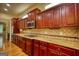 The kitchen features wood cabinets, stainless steel appliances, granite countertops, and a tiled backsplash at 705 Lawton Bridge Sw Rd, Smyrna, GA 30082