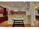 Well-lit kitchen featuring cherry wood cabinets, granite countertops, stainless appliances and a breakfast bar at 705 Lawton Bridge Sw Rd, Smyrna, GA 30082