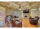 Spacious living room features coffered ceiling, stone fireplace, hardwood floors, and large windows at 705 Lawton Bridge Sw Rd, Smyrna, GA 30082