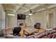 Cozy living room featuring coffered ceiling, stone fireplace, hardwood floors, and natural light at 705 Lawton Bridge Sw Rd, Smyrna, GA 30082