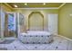 Beautiful main bathroom featuring a tiled shower and a large tiled soaking tub underneath an archway at 705 Lawton Bridge Sw Rd, Smyrna, GA 30082