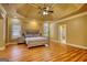 Bright main bedroom features tray ceiling, ceiling fan, large windows, and an ensuite bathroom at 705 Lawton Bridge Sw Rd, Smyrna, GA 30082