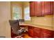 Office featuring wooden desk, granite countertop, matching cabinets, and natural lighting at 705 Lawton Bridge Sw Rd, Smyrna, GA 30082