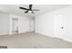Spacious main bedroom with neutral carpet and a ceiling fan and multiple closets and entry doors at 640 Cantrell Drive, Dallas, GA 30157