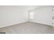 Cozy carpeted bedroom with neutral paint, window with blinds, and white trim at 82 Cantrell Drive, Dallas, GA 30157