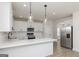Bright kitchen boasts white cabinets, stainless appliances, and an eat-in island at 82 Cantrell Drive, Dallas, GA 30157