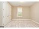 Bedroom featuring carpet flooring, a window, and closet at 444 Silverbell Ct, Peachtree City, GA 30269