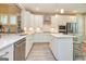 Bright, spacious kitchen with white cabinets, stainless steel appliances, and a center island at 444 Silverbell Ct, Peachtree City, GA 30269