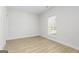 Bedroom featuring grey wood floors, white walls, a window, and white trim at 586 Cantrell Drive, Dallas, GA 30157