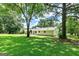 Large, private backyard with mature trees and a patio offering a peaceful outdoor retreat at 125 Selena Ct, Fayetteville, GA 30215