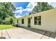 This backyard features a concrete patio and nice green grass at 125 Selena Ct, Fayetteville, GA 30215