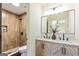 Modern bathroom features a double sink vanity, a large mirror, and a shower with decorative tiles at 125 Selena Ct, Fayetteville, GA 30215