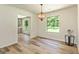 Dining area with a decorative light fixture, large windows providing ample natural light, and wood-look flooring at 125 Selena Ct, Fayetteville, GA 30215