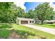 Wide angle view of the home featuring a long driveway leading to the two-car garage and a well-maintained lawn at 125 Selena Ct, Fayetteville, GA 30215