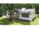 Charming home featuring stone accents, fresh landscaping, and a neatly maintained lawn at 125 Selena Ct, Fayetteville, GA 30215