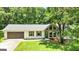 This home's front is stone and siding, with an attached garage, and well-manicured lawn at 125 Selena Ct, Fayetteville, GA 30215