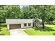 Charming home boasts an attached garage, stone accents, and a lush green lawn at 125 Selena Ct, Fayetteville, GA 30215