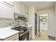 The kitchen has stainless steel appliances, including an oven, and updated cabinetry and hardware at 125 Selena Ct, Fayetteville, GA 30215