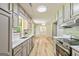 Contemporary kitchen with light grey cabinetry, stainless steel appliances, quartz countertops, and view to the living room at 125 Selena Ct, Fayetteville, GA 30215